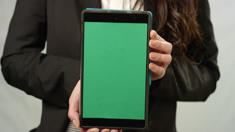 CU-Woman-Holding-Tablet-at-Camera-with-Green-Screen
