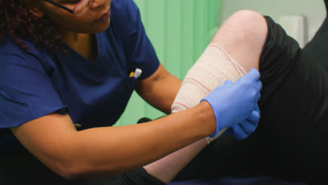 CU-Nurse-Finishes-Bandaging-Injured-Leg
