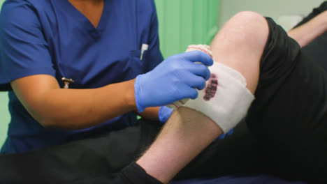 CU-Nurse-Bandaging-Bloody-Injured-Leg