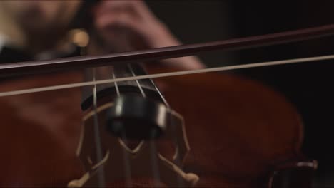 Close-Up-Hands-And-Bow-Of-Male-Cellist-Playing-Cello