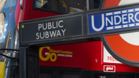 London-Bus-Passing-London-Underground-Sign