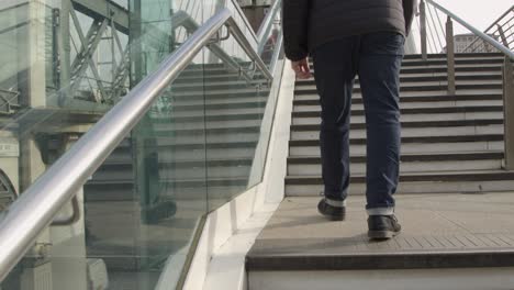 Man-Walking-Up-Steps-At-Embankment-London
