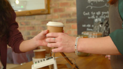 Handing-Coffee-to-Customer-in-Cafe-02