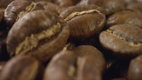 Macro-Close-Up-of-Coffee-Beans-Moving-Past-Camera