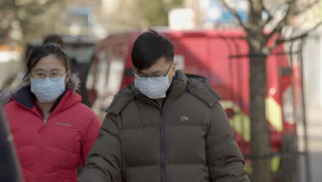 Male-and-Female-walking-on-street-wearing-face-masks