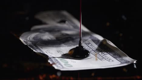 Oil-Being-Poured-Onto-100-Dollar-Bill