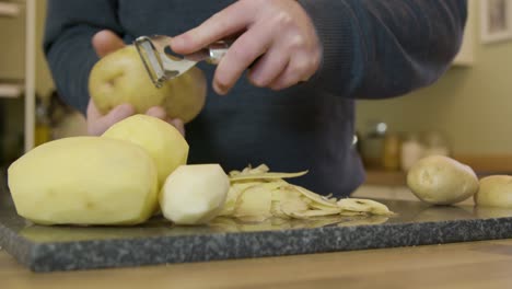 Tracking-In-Man-Peeling-Potatoes-in-Kitchen