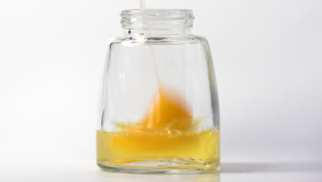 Slow-Motion-Close-Up-Egg-Whites-and-Yoke-Pouring-into-Jar