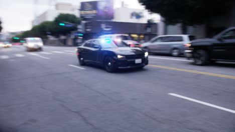 Hollywood-Police-Vehicles-with-Flashing-Siren-Driving-Past