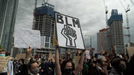 BLM-London-Protestor-Holds-Up-Power-Fist-Sign-in-Chanting-Crowd