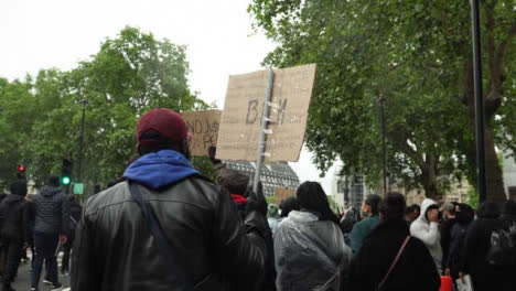 London-Black-Lives-Matter-Protester-Marches-Holding-Anti-Racism-Sign