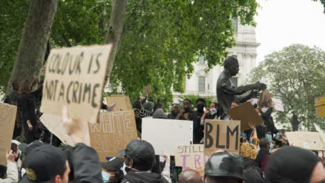 London-Black-Lives-Matter-Protester-Holds-Sign-Amongst-Chanting-Crowds
