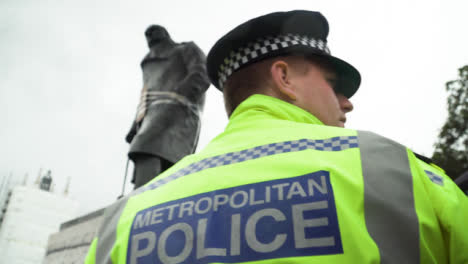 London-Police-Officer-Next-to-Graffitied-Churchill-Statue-During-Protest
