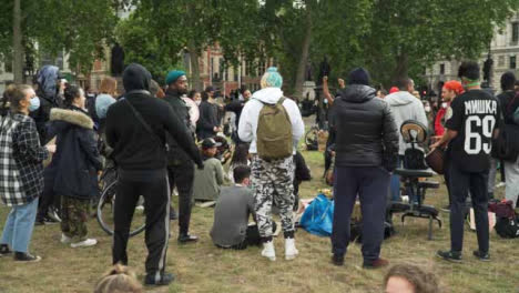 London-Group-of-Activists-Dancing-to-Music-in-Park
