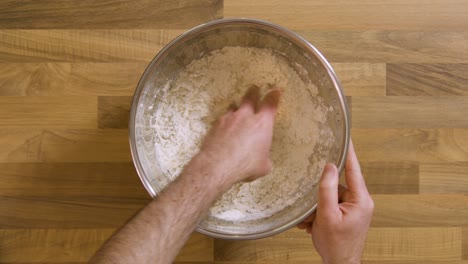 Top-View-Mixing-Ingredients-Into-a-Dough