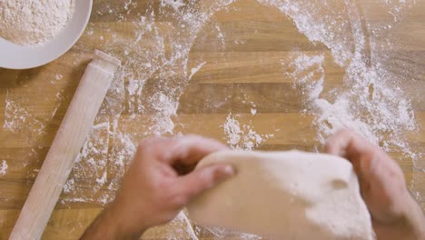 Top-View-Male-Shapes-and-Stretches-Dough-Time-Lapse