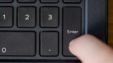 Top-View-Finger-Pressing-Enter-Keyboard-Button