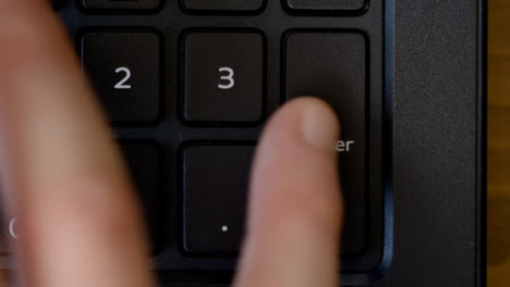 Top-View-Thumb-Pressing-Enter-Keyboard-Button