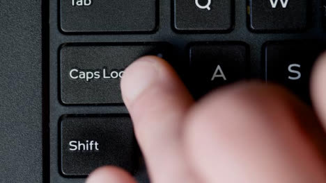 Top-View-Finger-Pressing-Caps-Lock-Button-Keyboard