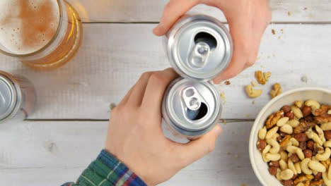 Top-View-Picking-Up-Beer-Cans-and-Toasting-Drinks