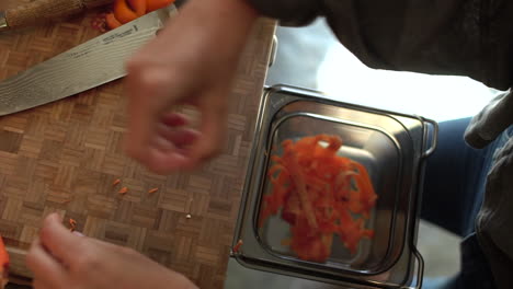 Close-Up-of-Female-Hands-Discarding-Carrot-Offcuts-into-Bin