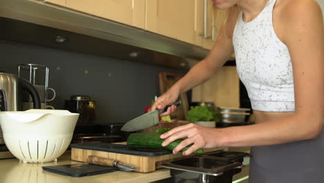 Dolly-In-Shot-of-Female-Hands-Slicing-Cucumber