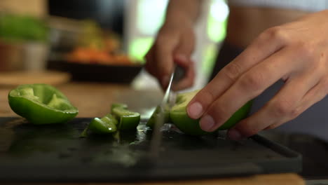 Close-Up-of-Female-Hands-Slicing-Green-Pepper