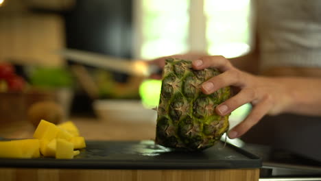 Close-Up-of-Female-Hands-Cutting-a-Slice-of-Pineapple-