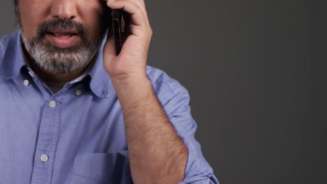 Middle-Aged-Man-Receiving-Bad-News-On-Phone-with-Copy-Space