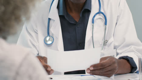 Mid-Section-Male-Doctor-Discussing-Results-With-Patient