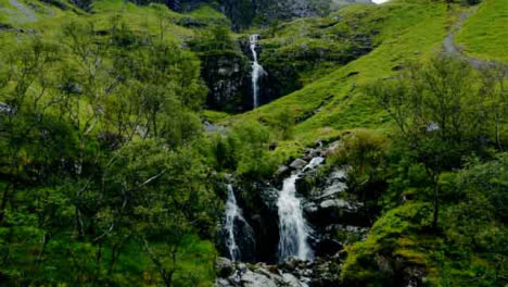 Aerial-Drone-Shot-of-Downhill-Stream-and-Waterfall-in-Glen-Coe