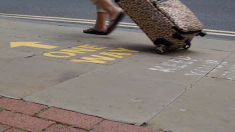 Close-Up-Shot-of-Feet-Walking-Over-One-Way-Pavement-Marking-In-Oxford-England