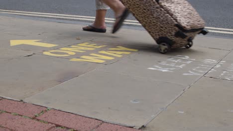 Close-Up-Shot-of-Feet-Walking-Over-One-Way-Pavement-Marking-In-Oxford-England