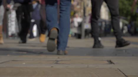 Defocused-Shot-of-Feet-Walking-Down-Cornmarket-Street-In-Oxford-