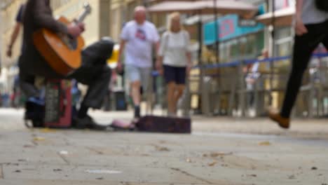 Low-Angle-Shot-of-Busker-On-Busy-Street-In-Oxford-01