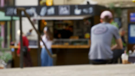 Defocused-Shot-of-Young-Girls-Walking-Away-from-Outdoor-Coffee-Stall-In-Oxford