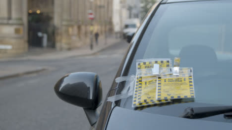 Close-Up-Shot-of-Parking-Tickets-On-Car
