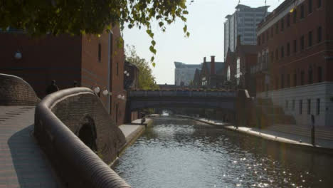 Panning-Shot-of-Two-Friends-Walking-Next-to-Birmingham-Canal