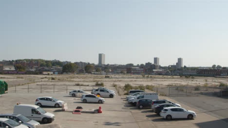 Tilting-Shot-of-Cars-Parked-In-Front-of-Desolate-Construction-Site