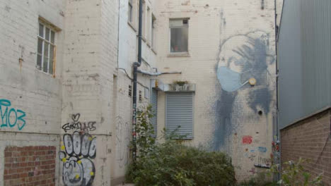 Tracking-Shot-Approaching-Banksy-Girl-Wearing-Pearl-Earrings-Artwork-In-Bristol-England