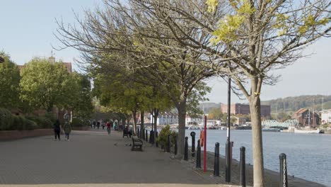 Tracking-Shot-Along-Busy-Waterside-Pathway-In-Bristol-England