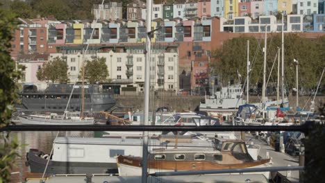 Tilting-Shot-of-Colourful-Waterside-Town-Houses-Overlooking-Marina-In-Bristol-England