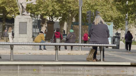 Wide-Shot-of-People-Sitting-On-Benches-On-Broad-Quay-In-Bristol-England