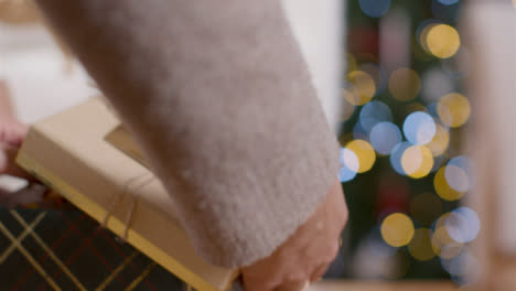Extreme-Close-Up-of-Young-Womans-Hands-Opening-Christmas-Present