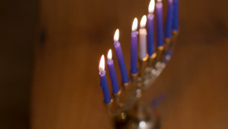 Extreme-Close-Up-of-Burning-Candles-On-Menorah-During-Hanukkah-