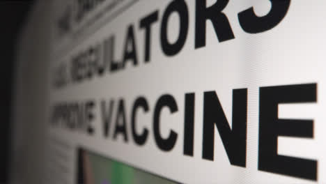 Sliding-Extreme-Close-Up-Shot-of-Coronavirus-Vaccine-Headline-On-Computer-Screen