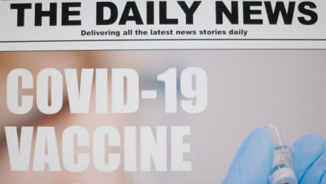 Close-Up-Shot-of-Scrolling-Covid-19-Vaccine-News-Article-Headline-On-Computer-Screen