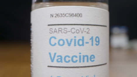 Sliding-Extreme-Close-Up-Shot-of-Covid-19-Vaccine-Vial-
