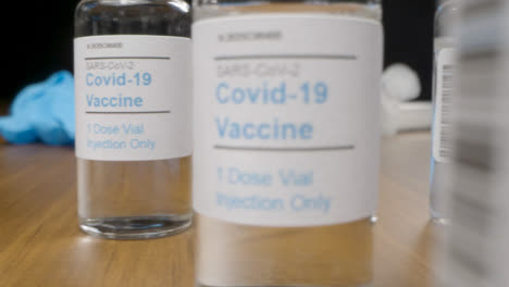 Sliding-Close-Up-Shot-Past-Syringes-and-Vials-of-Covid-19-Vaccine-