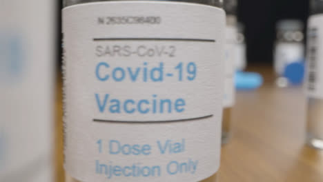 Sliding-Close-Up-Shot-Past-Syringes-and-Vials-of-Coronavirus-Vaccine-